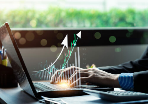 Businessman using laptop and analyzing economic growth, financial graph and business investment. planning strategy, stock market statistics, stock market trends, technical analysis strategy, value